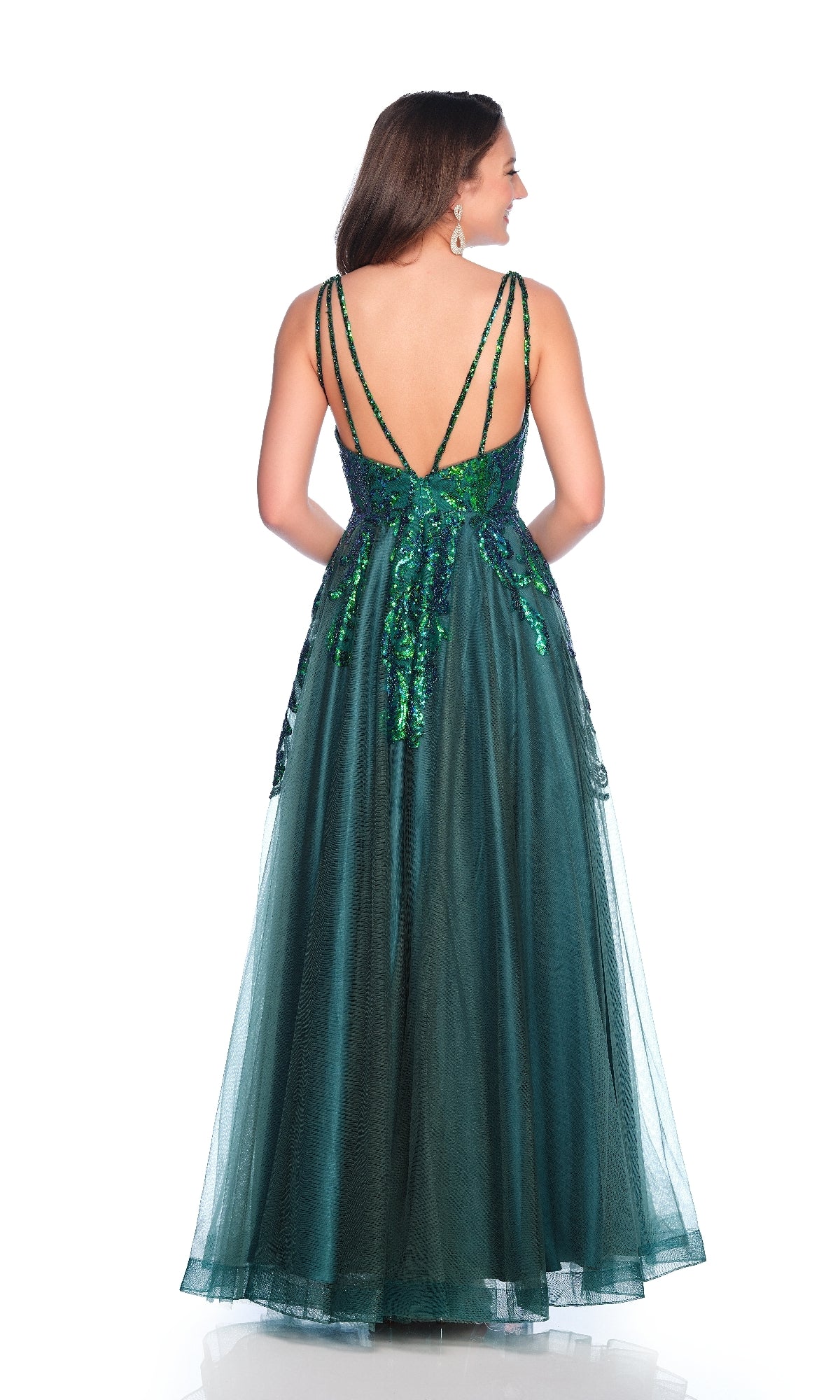 A woman stands facing away from the camera in the Dave & Johnny 12064 Emerald Green Prom Dress, featuring a sequin bodice and sleeveless, floor-length A-line tulle skirt, set against a white background.